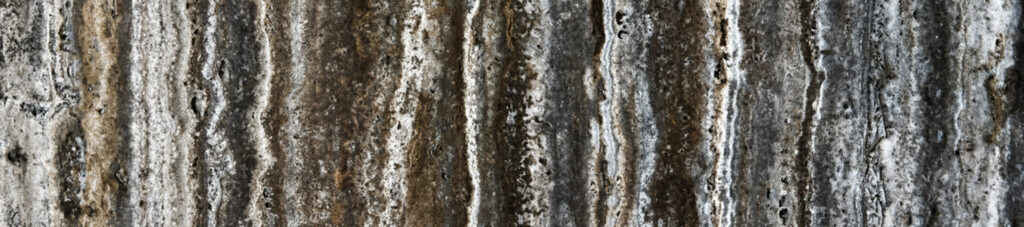 Close-up of Silver Titanium Travertine from Silverex Quarry, featuring natural silver, grey, and brown linear veins with a porous texture.